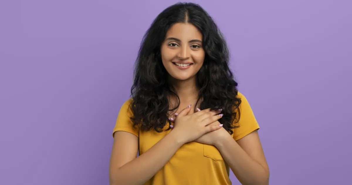 happy young eastern lady holding hands chest (1) (1)